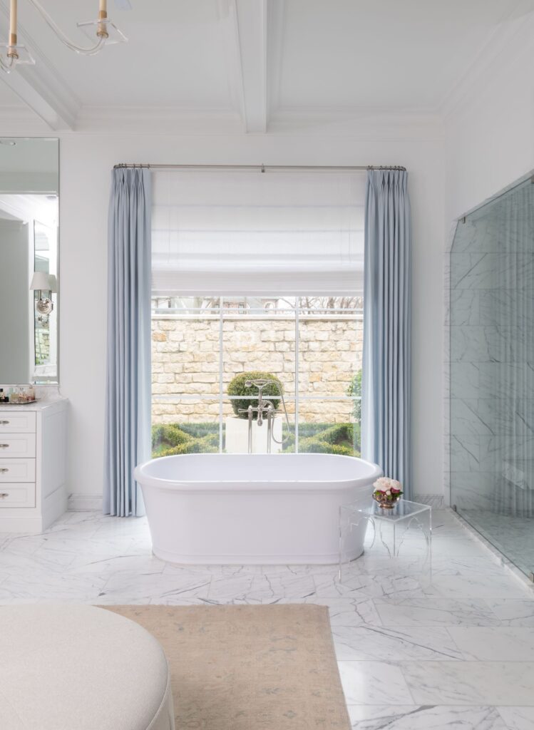 freestanding tub in front of large window in dallas bathroom remodel